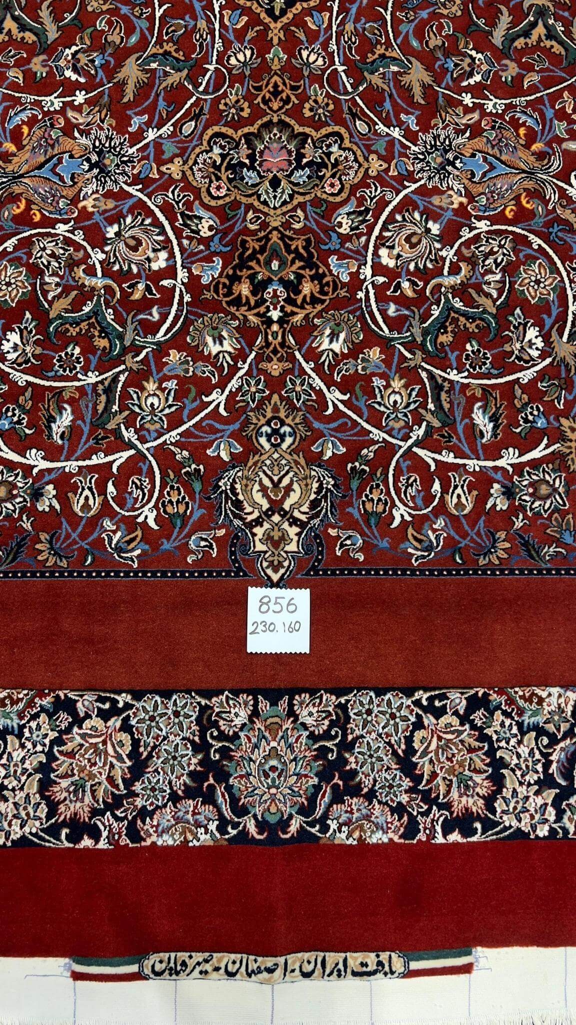 "Artistic Persian rug with vibrant red and navy colors and natural dyes."